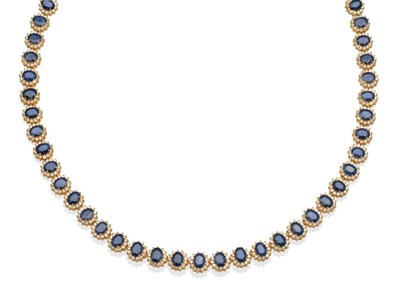 Lot 228 - A Sapphire and Diamond Necklace, thirty-nine clusters of oval mixed cut sapphires within borders of