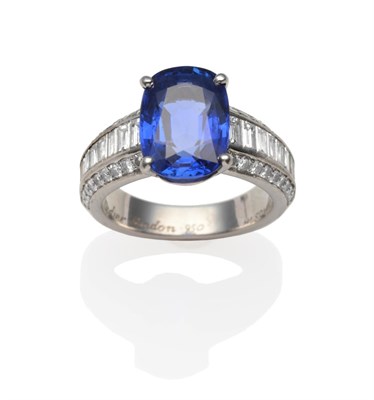 Lot 366 - A Sapphire and Diamond Ring, by Cartier, the cushion mixed cut sapphire in four white claws to...