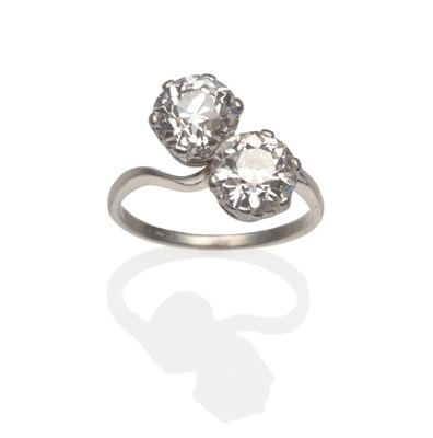 Lot 390 - A Diamond Two Stone Twist Ring, two old cut diamonds in white claw settings on a plain polished...