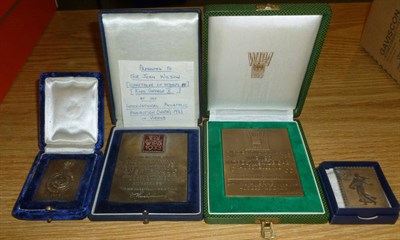 Lot 117 - A White Metal and enamel plaques WIPA 1933 and 1965, both cased and two other white metal...