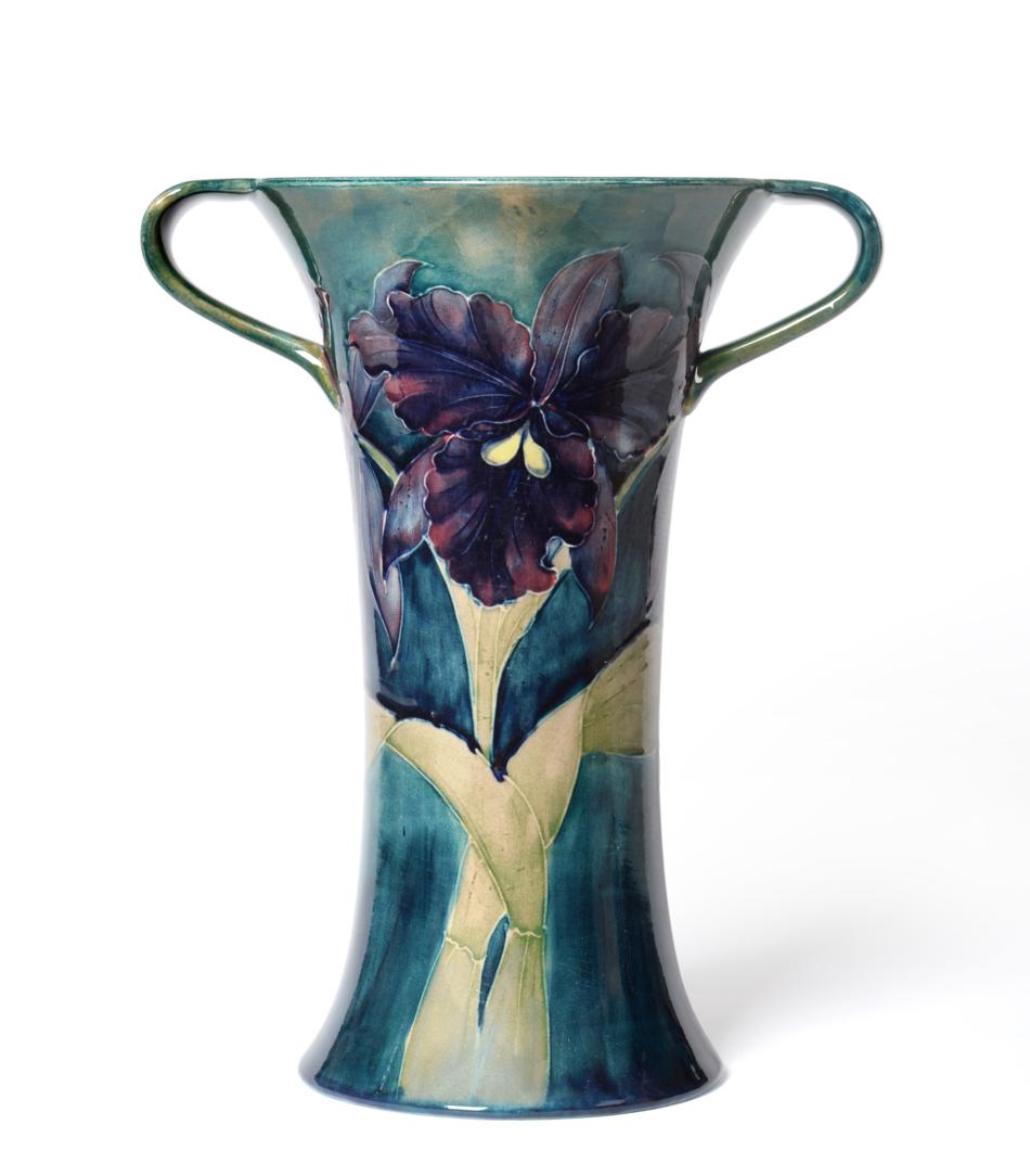 Lot 554 - A William Moorcroft Orchid Pattern Twin-Handled Vase, circa 1918, with purple and mauve orchids...