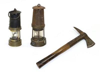 Lot 5119 - Miners' Lamps one stamped '937' the other unmarked; together with an ARP Fire Axe stamped '1940 The