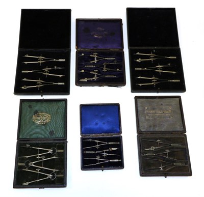 Lot 5144 - Various Compass Sets each with three compasses in leatherette covered cases (6)