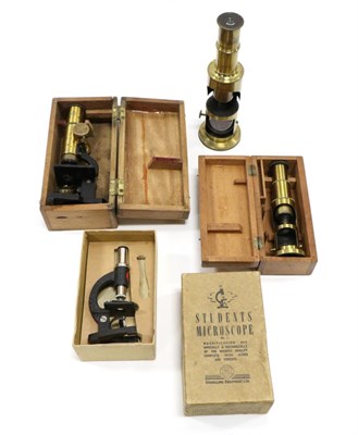 Lot 5158 - Four Microscopes (i) Brass field microscope (ii) Student microscope with black lacquered base...