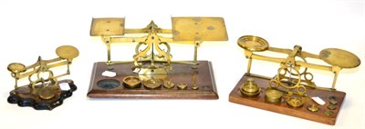 Lot 174 - Three Brass Balances on wooden bases with assorted weights (3)