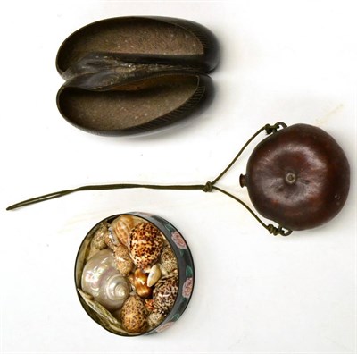 Lot 552 - Coco de Mer Nut, portion cut away to form a carrying vessel with carved horizontal decoration...