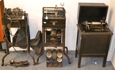 Lot 81 - Edison Three Dictaphones Type S No.3859 with wooden hinged lid, and two others on metal stands,...