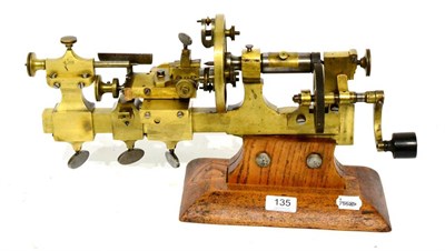 Lot 135 - Watchmakers Lathe in brass and steel with hand wind, on wooden base 19";, 49cm long