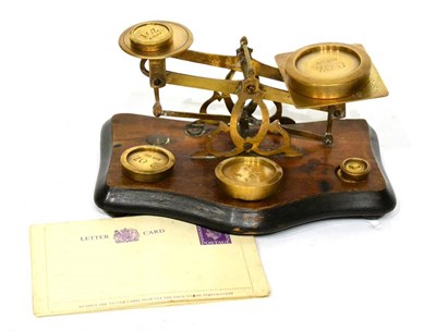 Lot 203 - Postal Scales brass scales on wooden base with one pan engraved with postal rates up to 12oz,...