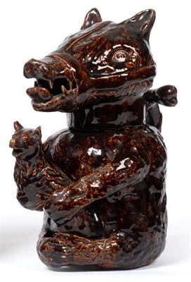Lot 14 - A Staffordshire Treacle Glaze Bear Jug and Cover, circa 1830, naturalistically modelled holding...