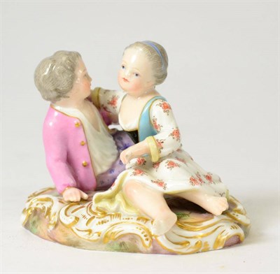 Lot 22 - A Meissen Porcelain Figure Group, late 19th century, as a boy and girl sitting on a mound, on a...