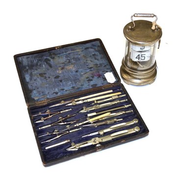 Lot 13 - Flick Timepiece with glass tube and base metal case 5";, 13cm high together with a Compass Set...