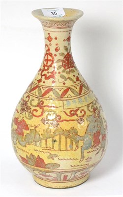 Lot 35 - A Chinese Provincial Porcelain Bottle Vase, painted in blue and red enamels with a procession...