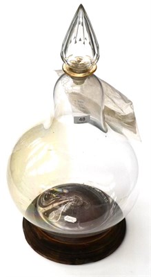 Lot 48 - Chemist Glass Carboy of lightbulb form with glass stopper on wooden base, used as display...