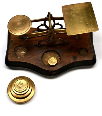 Lot 38A - Postal Scales brass scales on wooden base with one pan engraved with postal rates up to 12oz,...