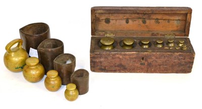 Lot 61 - A Cased Part Set of Nine Spherical Brass Weights, sizes from 4lb to 1/4oz (one missing), in a...