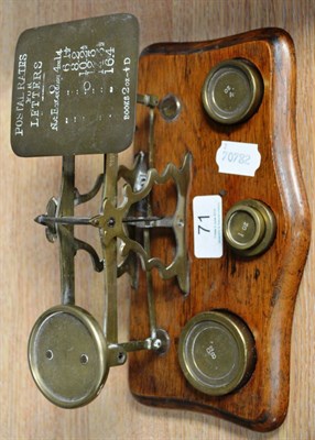 Lot 71 - Brass Postal Scales on wooden base with 1oz, 2oz, 4oz and 8oz weights, with flat side of scales...