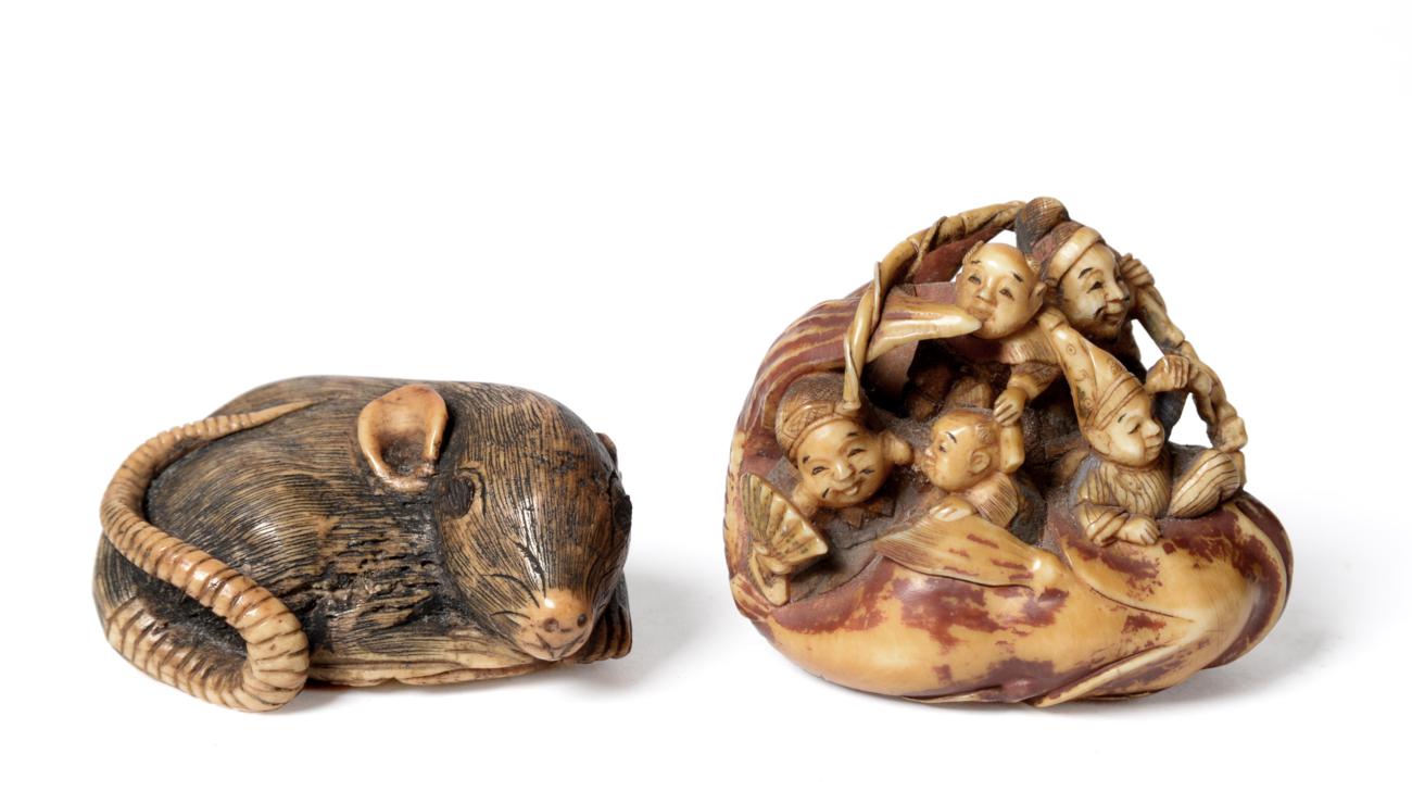 Lot 75 - A Japanese Stained Ivory Netsuke, 19th century, as a group of figures riding on the back of a large