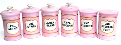 Lot 103 - A Set of Six Pink Pottery Drug Jars, with shield shaped gilt labels, black lettering, four with...