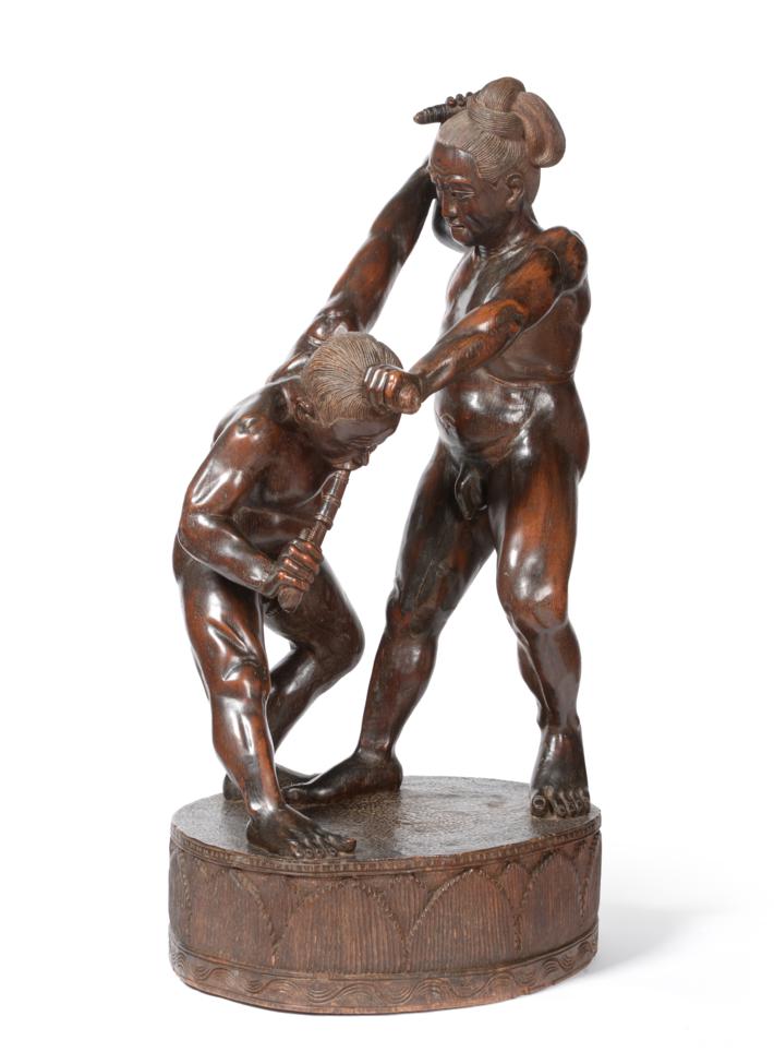 Lot 86 - A Japanese Hardwood Large Figure Group, 19th century, as two nude warriors wrestling, on a drum...