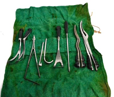 Lot 162 - A Roll of Ebony Handled Obstetric Instruments, includes two pairs of craniotomy forceps,...