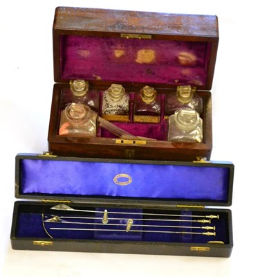 Lot 195 - A 19th Century Mahogany Cased Travelling Pharmacy Set, containing five glass bottles with stoppers