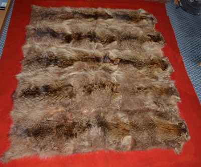 Lot 349 - An Animal Skin Mounted Red Wool Car Rug, probably circa 1930, composed of five pelts, possibly...