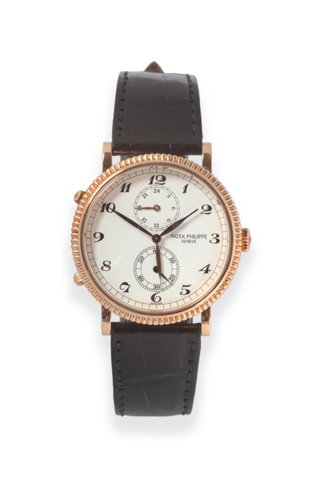 Lot 119 - ~ An 18ct Gold Dual Time Zone Wristwatch, signed Patek Philippe, Geneve, model: travel time,...