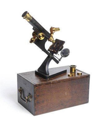 Lot 67 - A compound microscope by R & J Beck No 15931. A star model monocular microscope on a cast iron...
