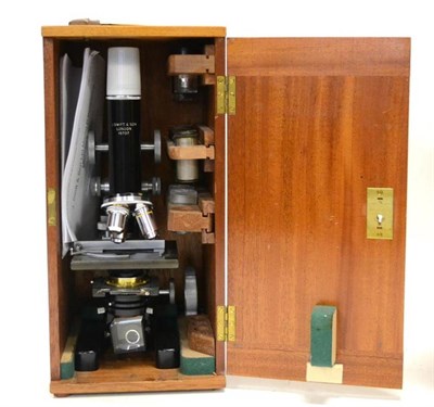 Lot 105 - J Swift Model P Polarizing Microscope black lacquered metal with three lens turret, slide...