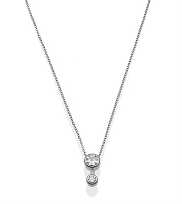 Lot 165 - An 18 Carat White Gold Diamond Pendant, two round brilliant cut diamonds in collet settings,...