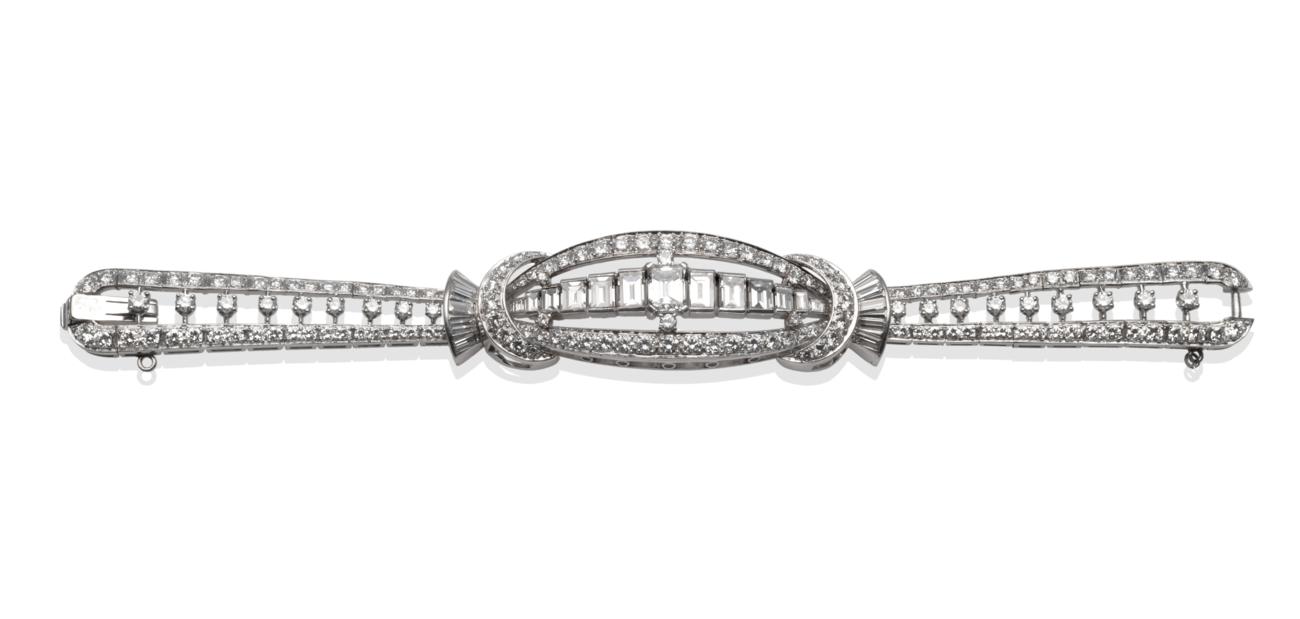 Lot 191 - ~ A Diamond Bracelet, graduated baguette cut diamonds centrally within a round brilliant cut...