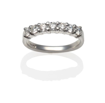 Lot 193 - A Platinum Diamond Half Hoop Ring, seven round brilliant cut diamonds in claw settings, total...