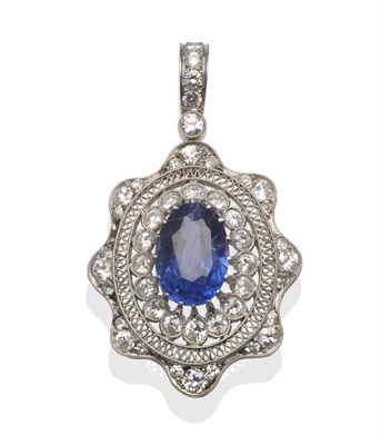 Lot 203 - An Early 20th Century Sapphire and Diamond Pendant/Brooch, the oval mixed cut sapphire within a...