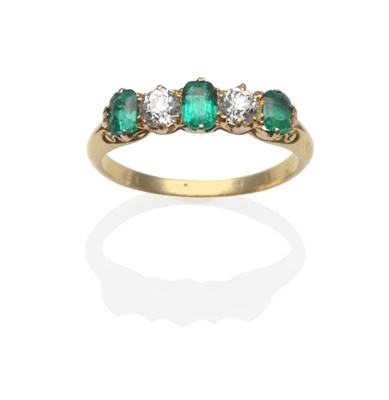 Lot 214 - An Emerald and Diamond Five Stone Ring, three emerald-cut emeralds alternate with two old cut...