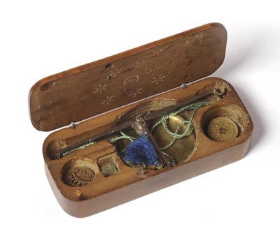 Lot 1029 - Guinea Scale, 18th Century in walnut case with stars and moon carved inside lid with two 'coin' and