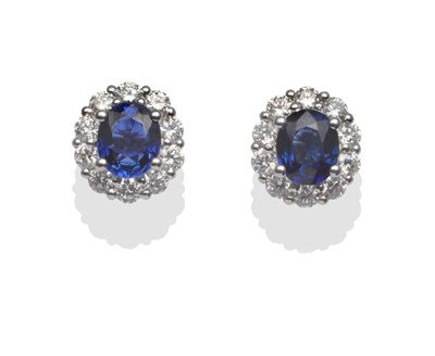 Lot 224 - A Pair of Sapphire and Diamond Cluster Stud Earrings, the oval cut sapphires in a border of...