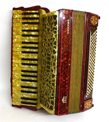 Lot 1110 - A Hohner Piano Accordion, with red pearl body and gold pearl keys, cased