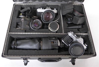 Lot 1153 - Four 35mm Cameras -  Canon TLb, Canon AE-1, Canon F-1 and an Olympus OM-20, together with...