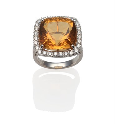 Lot 237 - An 18 Carat White Gold Citrine and Diamond Cluster Ring, the cushion cut citrine within a border of