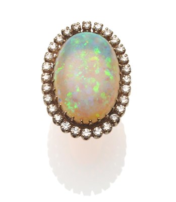 Lot 241 - An Opal and Diamond Cluster Ring, an oval cabochon opal within a border of round brilliant cut...