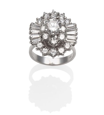 Lot 244 - ~ A Diamond Cluster Ring, a central round brilliant cut diamond within borders of round...