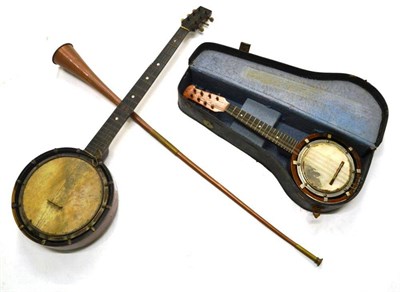 Lot 1007 - Mixed Instruments, including two banjos, brass pumps, surveying level, corkscrews, hydrometer,...