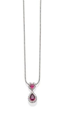 Lot 253 - An 18 Carat White Gold Ruby and Diamond Pendant on Chain, a heart shaped ruby within a border...