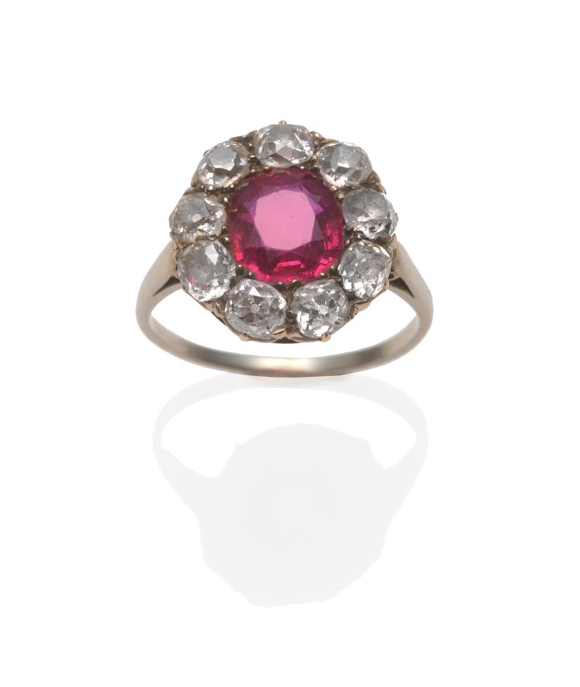 Lot 266 - A Ruby and Diamond Cluster Ring, circa 1900, the cushion mixed cut ruby within a border of nine old