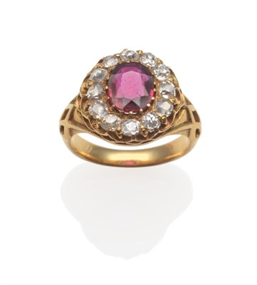 Lot 269 - A Ruby and Diamond Cluster Ring, circa 1890, an oval mixed cut ruby within a border of old cut...