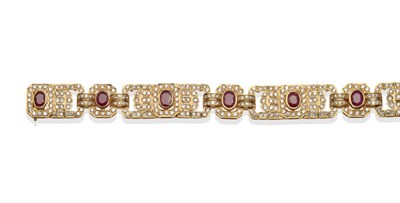 Lot 273 - ~ A Ruby and Diamond Bracelet, oval rubies in yellow rubbed over settings, within articulated...