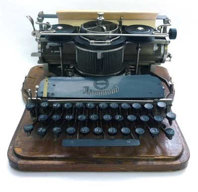 Lot 1009 - A Hammond Multiplex Typewriter, serial number 150688, mounted on an oak base, with bentwood oak lid