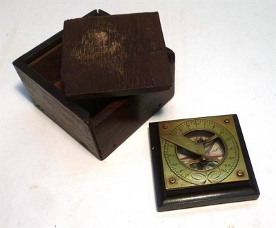 Lot 1016 - A Small Pocket Sundial/Compass, the brass sundial with folding gnomon, mounted on a wooden...