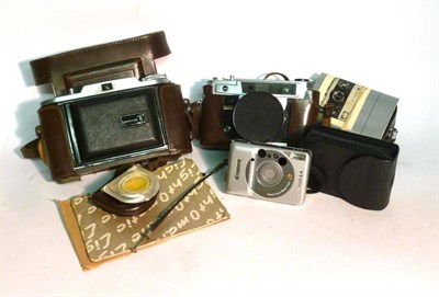 Lot 1227 - Four Cased Cameras - Voightlander Bessa I, Rollei 35, Lightomatic III and Canon Ixus L1